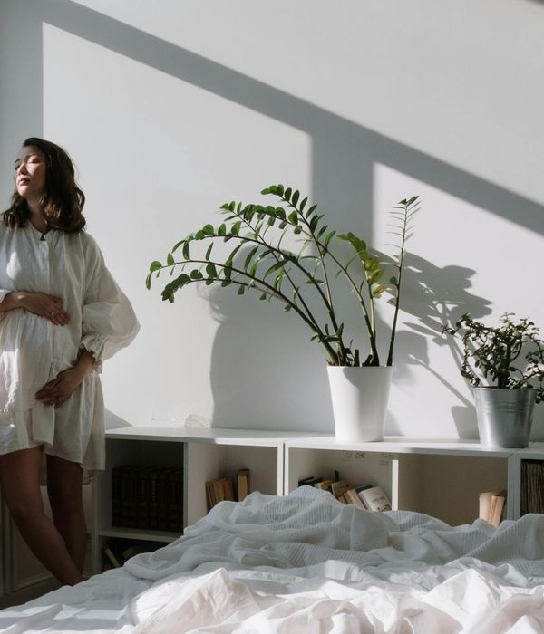 A person meditating peacefully by a window with soft morning light.