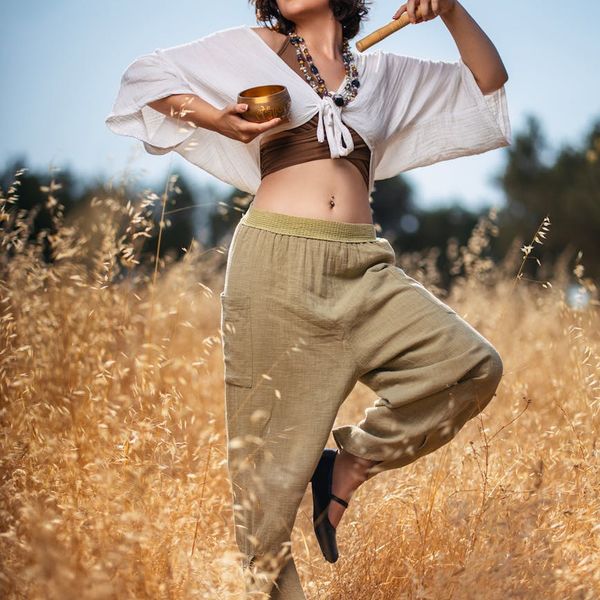 Woman in a peaceful yoga pose in a bright, serene environment.